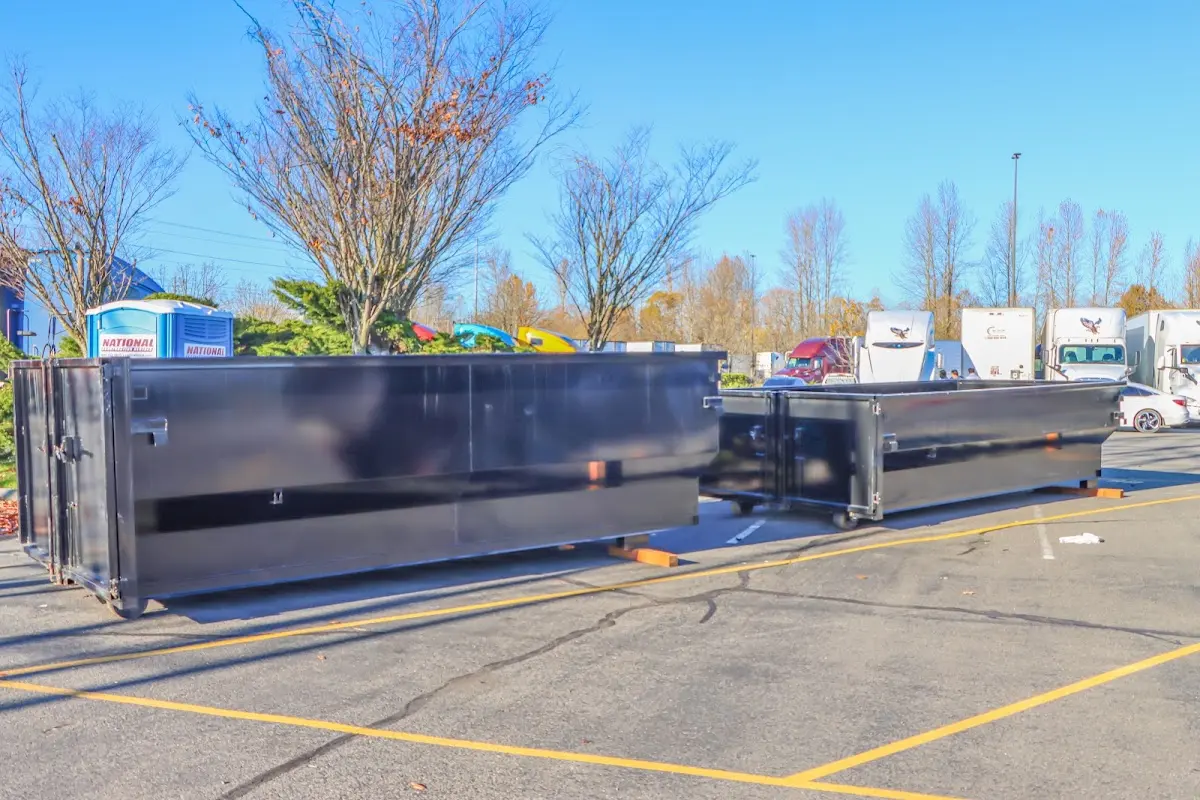 Professional dumpster rental service with roll-off container on residential driveway in Coventry